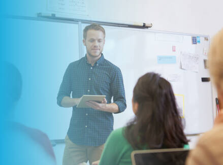 Instructor in front of a classroom with adult learners